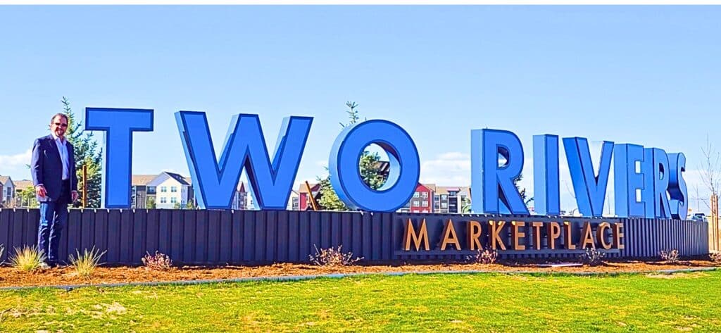 John Stephens, owner and developer of Two Rivers Marketplace in west Greeley, stands next to the new community monument sign. The Stephens family farmed the land, now under development, for nearly 50 years. Planned are 400 homes and 250 apartments on 160 acres. Immediately adjacent to the housing will be 29 acres of commercial developments.