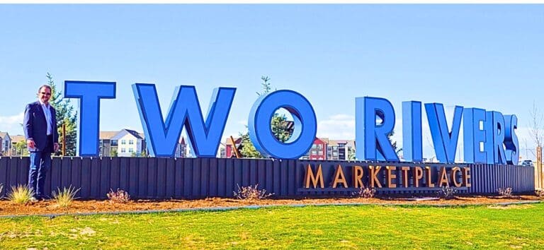 John Stephens, owner and developer of Two Rivers Marketplace in west Greeley, stands next to the new community monument sign. The Stephens family farmed the land, now under development, for nearly 50 years. Planned are 400 homes and 250 apartments on 160 acres. Immediately adjacent to the housing will be 29 acres of commercial developments.