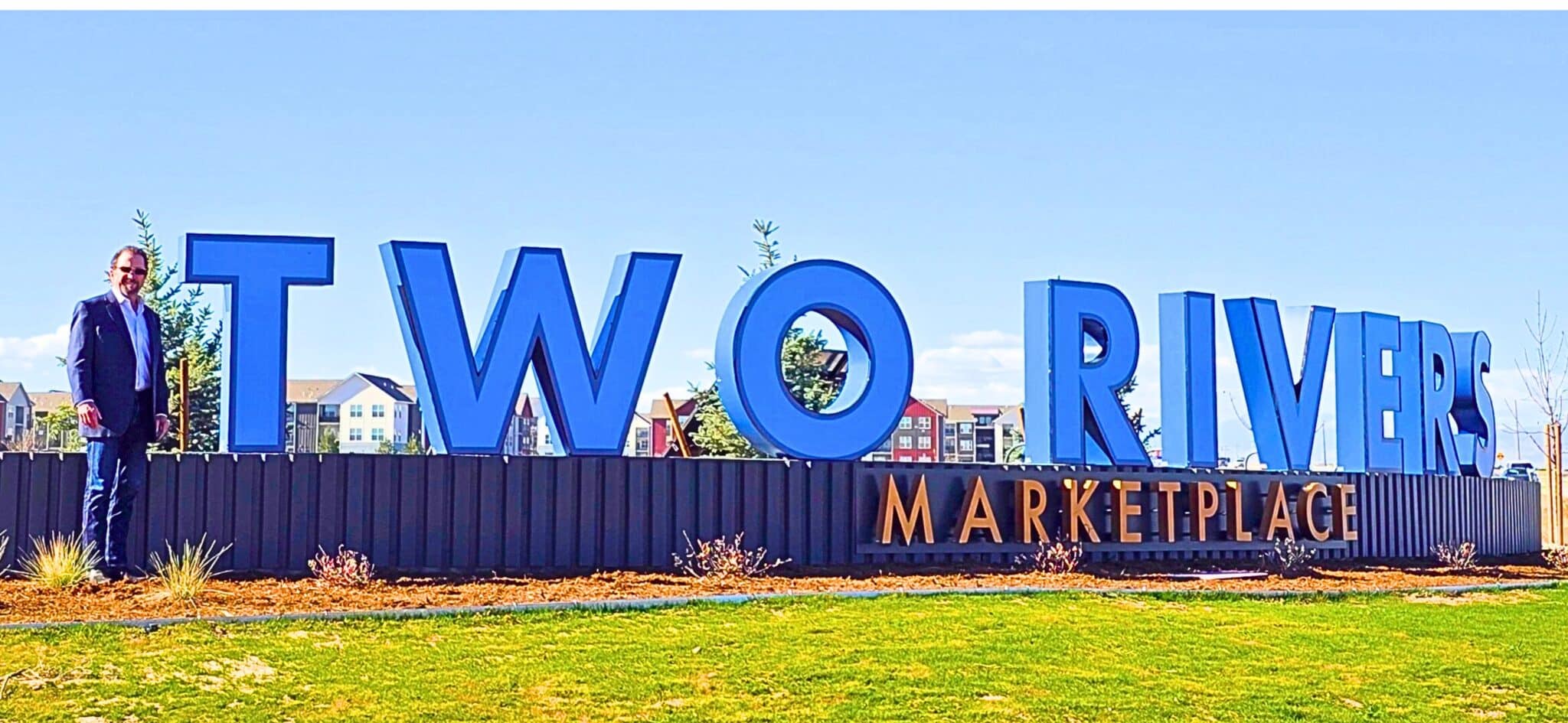 John Stephens, owner and developer of Two Rivers Marketplace in west Greeley, stands next to the new community monument sign. The Stephens family farmed the land, now under development, for nearly 50 years. Planned are 400 homes and 250 apartments on 160 acres. Immediately adjacent to the housing will be 29 acres of commercial developments.